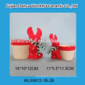 Weihnachtskeramik-Teelichthalter in rotem Rentier und weißem Schneeball